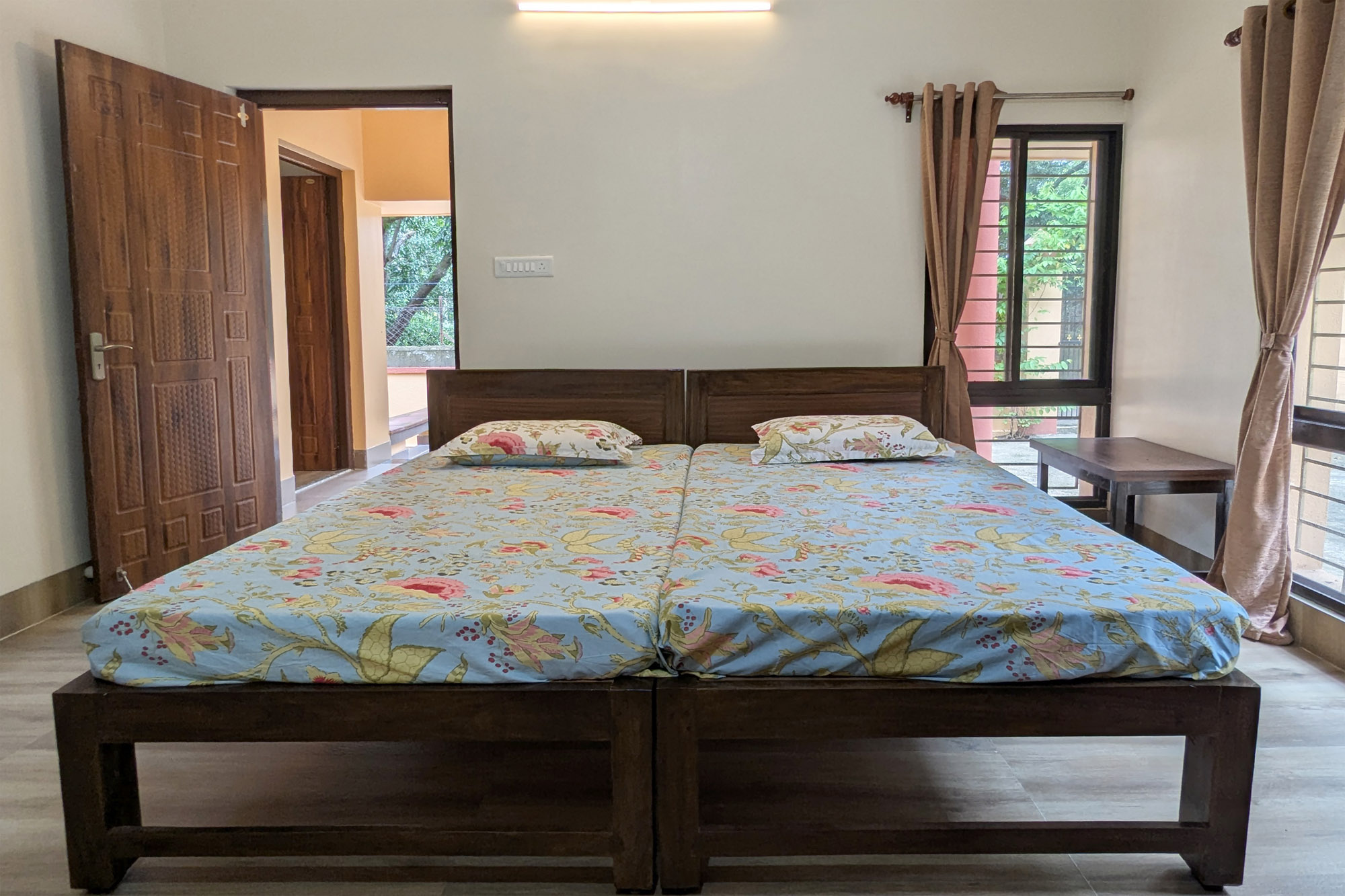 Deluxe bedroom with twin beds and windows.