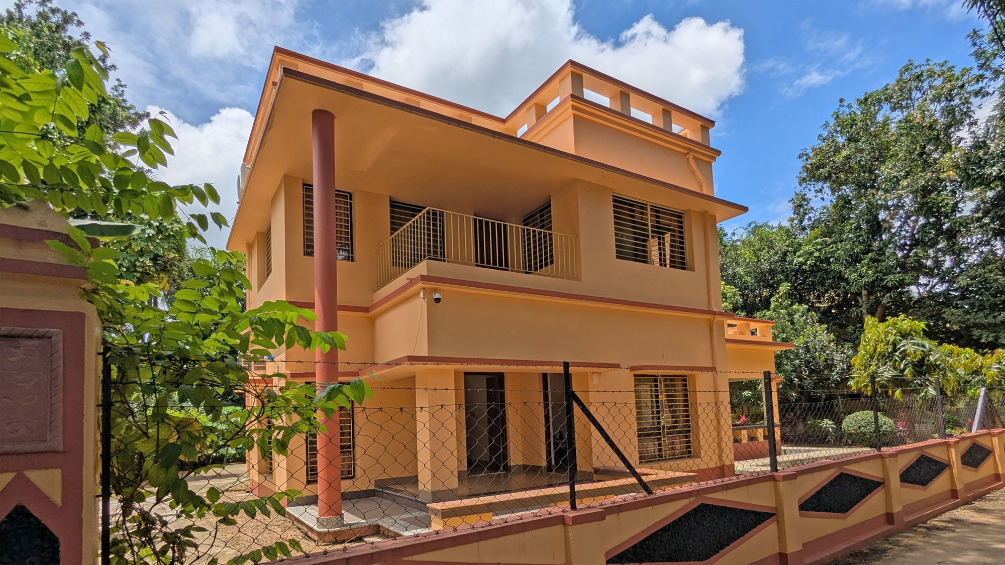 Premium bedroom at Shanti Niwas with twin beds, warm curtains and garden view.